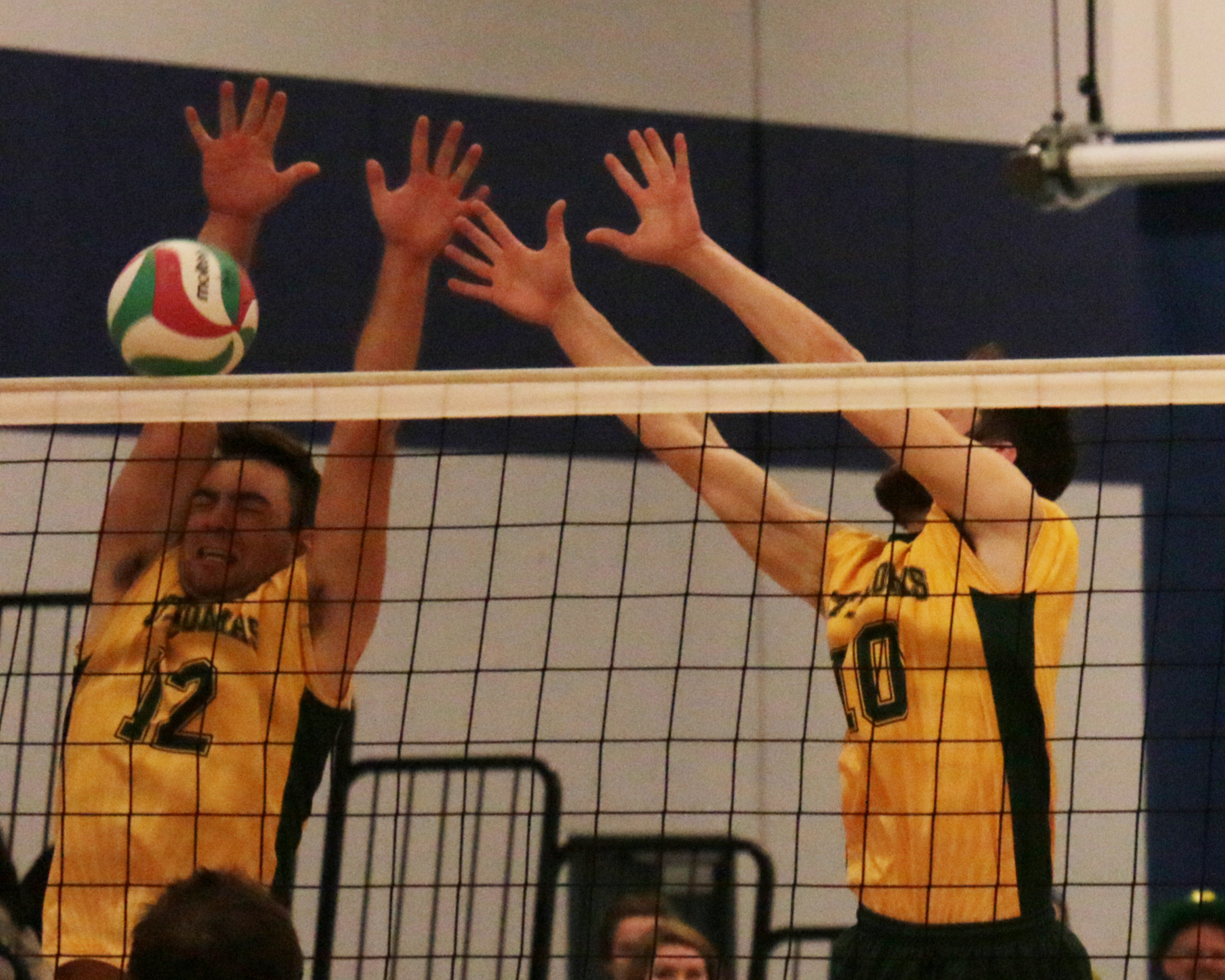 Ryan Dickson and Francis Sirois put up a block for the Tommies.